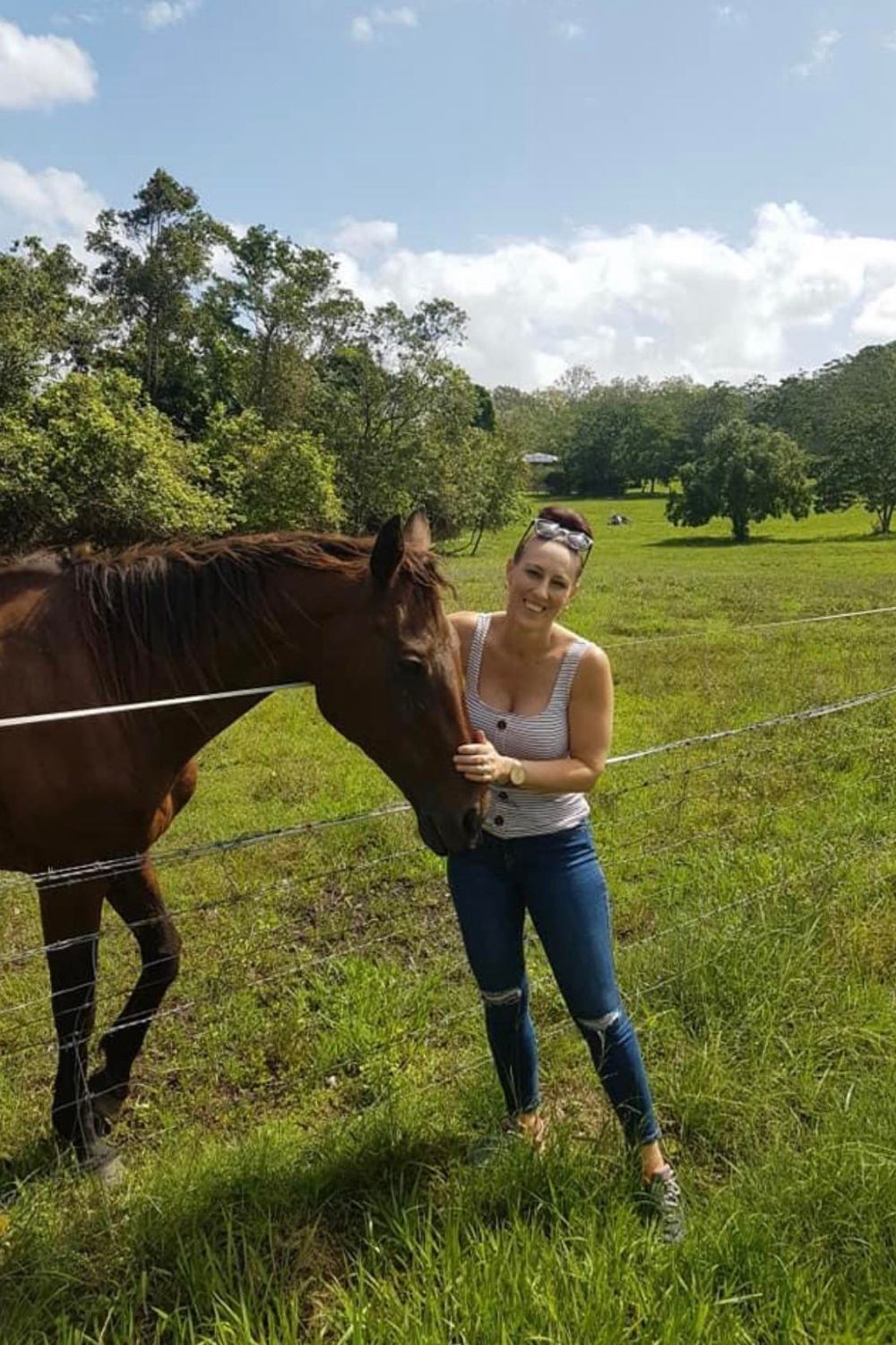 A photo of the Pilates 2 U owner with horse in the background.