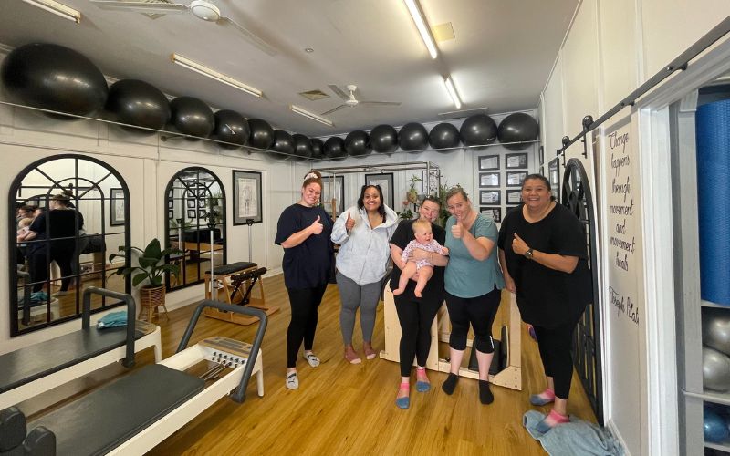 a group of people during a pilates session.